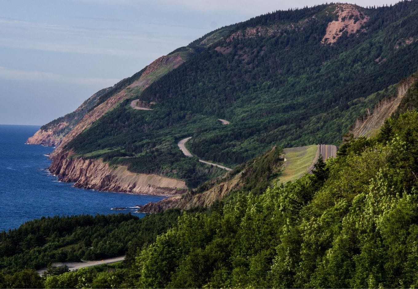 The Cabot Trail Road surrounded by green forests, at Nova Scotia.