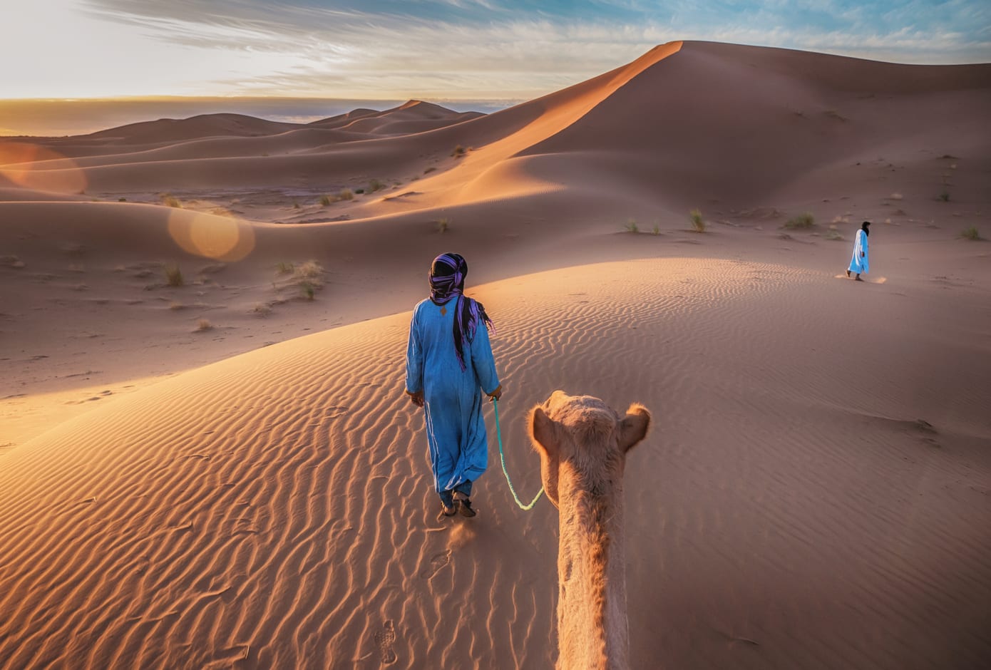 Nomad with camel in the Sahara Desert, Morocco.